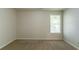 Bedroom featuring neutral colored walls and carpet with a window at 6528 Carriage Ln, Stone Mountain, GA 30087
