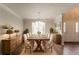 Formal dining room with hardwood floors, elegant lighting, and seating for eight at 6528 Carriage Ln, Stone Mountain, GA 30087