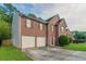 Charming two-story brick home with two-car garage and well-manicured lawn at 6528 Carriage Ln, Stone Mountain, GA 30087