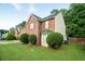 A well maintained two-story brick home with a green lawn and mature landscaping at 6528 Carriage Ln, Stone Mountain, GA 30087