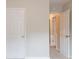 Hallway featuring neutral carpet flooring and multiple doors at 6528 Carriage Ln, Stone Mountain, GA 30087