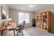Bright home office featuring a desk, bookcase, and plenty of natural light at 6528 Carriage Ln, Stone Mountain, GA 30087
