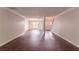 Spacious living room with hardwood floors and neutral paint, leading to the entry and staircase at 6528 Carriage Ln, Stone Mountain, GA 30087
