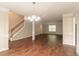 Open living area with hardwood floors and a staircase, perfect for entertaining and Gathering gatherings at 6528 Carriage Ln, Stone Mountain, GA 30087