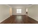 Expansive living room featuring hardwood floors, neutral walls, and plenty of natural light at 6528 Carriage Ln, Stone Mountain, GA 30087