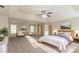 Spacious primary bedroom with a ceiling fan, sitting area, and natural light at 6528 Carriage Ln, Stone Mountain, GA 30087