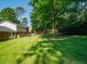 Expansive backyard featuring mature trees, a trampoline, and well-maintained lawn, creating a private retreat at 1373 Brawley Ne Cir, Brookhaven, GA 30319