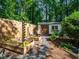 Backyard garden with planter beds and a shed surrounded by a wooden fence, enhancing the property's charm at 1373 Brawley Ne Cir, Brookhaven, GA 30319