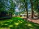 Lush backyard featuring a trampoline, mature trees, and well-manicured lawn, perfect for outdoor activities and relaxation at 1373 Brawley Ne Cir, Brookhaven, GA 30319
