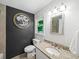 Modern bathroom with decorative mirror and tree art on the wall at 1373 Brawley Ne Cir, Brookhaven, GA 30319