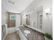 Well-lit bathroom with granite countertop, large mirror, and shower with tiled walls at 1373 Brawley Ne Cir, Brookhaven, GA 30319