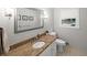 Bright bathroom with granite countertop, white cabinets, modern fixtures, and decorative mirror at 1373 Brawley Ne Cir, Brookhaven, GA 30319
