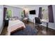Stylish bedroom with hardwood floors, purple accents, ample windows, and a comfortable bed at 1373 Brawley Ne Cir, Brookhaven, GA 30319