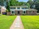 Charming two-story home with a beautifully landscaped yard and inviting stone pathway at 1373 Brawley Ne Cir, Brookhaven, GA 30319