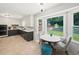 Bright eat-in kitchen features bay window, modern finishes, and a cozy breakfast nook at 1373 Brawley Ne Cir, Brookhaven, GA 30319
