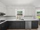 Well-lit kitchen boasts ample counter space, two-tone cabinets, and modern appliances at 1373 Brawley Ne Cir, Brookhaven, GA 30319