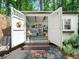 Charming shed with open doors, revealing a cozy interior and inviting outdoor space for relaxation or hobbies at 1373 Brawley Ne Cir, Brookhaven, GA 30319