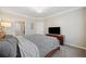 Comfortable bedroom with wood bed frame and dresser, TV and a glimpse of the ensuite bathroom at 1850 Cotillion Dr # 3114, Atlanta, GA 30338