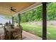 Covered back porch with wood ceiling, fan, dining table, and green backyard at 2490 S Carroll S St, Villa Rica, GA 30180