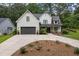 Charming two-story white farmhouse with a dark gray garage door and well-manicured landscaping at 2490 S Carroll S St, Villa Rica, GA 30180