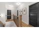 Bright hallway with wood railing, black door, and decorative wall art at 2490 S Carroll S St, Villa Rica, GA 30180