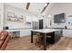 Modern kitchen with white cabinets, a contrasting black island, stainless steel appliances, and wood beam accents at 2490 S Carroll S St, Villa Rica, GA 30180