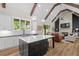 Spacious kitchen with a center island, white cabinets, and a view into the adjacent living room with fireplace at 2490 S Carroll S St, Villa Rica, GA 30180