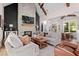 Inviting living room featuring a stone fireplace, wood beams, and seamless transition to the adjacent dining area at 2490 S Carroll S St, Villa Rica, GA 30180