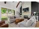 Cozy living room with a stone fireplace, wood beam accent, and sliding glass doors leading to the backyard at 2490 S Carroll S St, Villa Rica, GA 30180