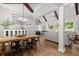 Open-concept living and dining area with wood beams, modern lighting, and ample natural light from the adjacent windows at 2490 S Carroll S St, Villa Rica, GA 30180