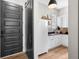 Chic mud room with a barn door, white cabinets, granite countertops, and sleek fixtures at 2490 S Carroll S St, Villa Rica, GA 30180