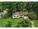 An aerial view of a beautiful home surrounded by lush greenery at 3833 Paddington Trail, Rex, GA 30273