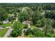 Scenic aerial shot showcasing the home's location within a lush, green neighborhood with tree-lined streets at 3833 Paddington Trail, Rex, GA 30273
