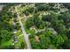 Aerial view of a neighborhood featuring mature trees, manicured lawns, and well-maintained streets at 3833 Paddington Trail, Rex, GA 30273
