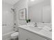 Bright bathroom featuring a shower-tub combination, a plant, a framed picture, and a mirror at 3833 Paddington Trail, Rex, GA 30273