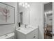 Small renovated bathroom featuring a toilet, vanity, and decorative mirror at 3833 Paddington Trail, Rex, GA 30273