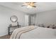 Well-lit bedroom features a ceiling fan, neutral paint, and access to the walk-in closet at 3833 Paddington Trail, Rex, GA 30273