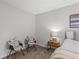 Cozy bedroom features comfortable seating, a nightstand, and a soft rug at 3833 Paddington Trail, Rex, GA 30273