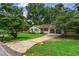 Charming single-story home with a well-manicured lawn and an attached two-car garage at 3833 Paddington Trail, Rex, GA 30273