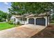 Charming home with two-car garage, manicured lawn, and a white porch at 3833 Paddington Trail, Rex, GA 30273