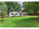 Charming single-story home featuring black shutters, a front porch, and an attached two-car garage at 3833 Paddington Trail, Rex, GA 30273