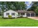 Charming home featuring black shutters, a front porch, and an attached two-car garage at 3833 Paddington Trail, Rex, GA 30273
