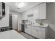 Bright kitchen features white cabinetry, stainless steel appliances, and quartz countertops at 3833 Paddington Trail, Rex, GA 30273