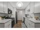 Updated kitchen boasts quartz countertops, stainless appliances, and wood-look floors at 3833 Paddington Trail, Rex, GA 30273