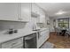 Open kitchen with stainless appliances, a view to the dining area and modern countertops at 3833 Paddington Trail, Rex, GA 30273
