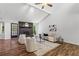 Cozy living room featuring a stone fireplace, wood floors, and ample natural light at 3833 Paddington Trail, Rex, GA 30273
