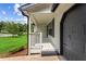 Covered front porch leading to an attached two-car garage at 3833 Paddington Trail, Rex, GA 30273
