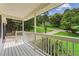 Covered front porch overlooking the yard and street at 3833 Paddington Trail, Rex, GA 30273