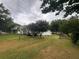 Spacious backyard with a mix of grass, trees and small buildings at 4706 Piney Grove Rd, Cumming, GA 30040