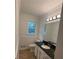 Bathroom featuring new flooring, stone countertop sink and lighting fixtures at 4706 Piney Grove Rd, Cumming, GA 30040